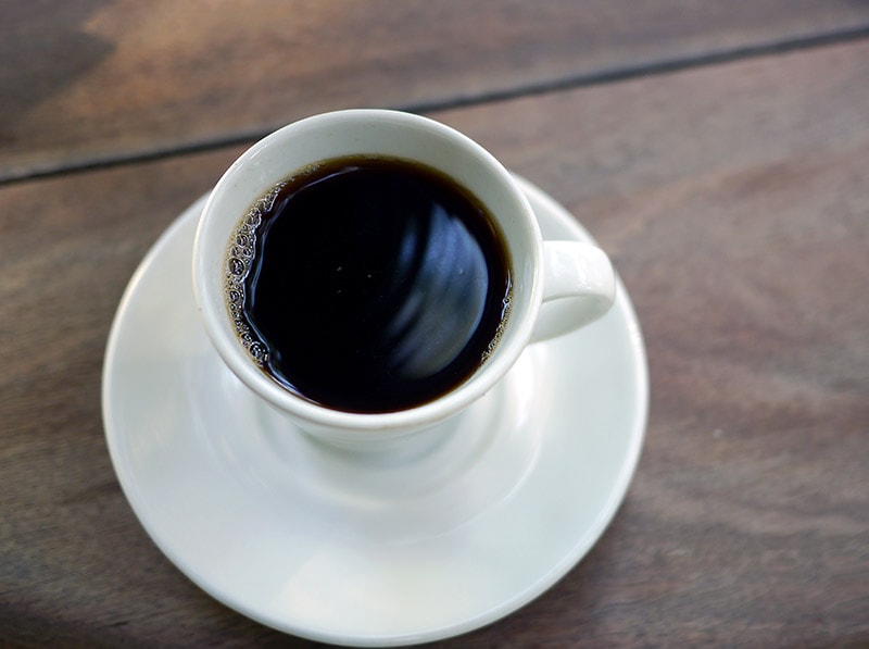 a cup of coffee on wooden table